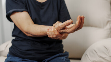 Close up hands of asian senior elderly woman with parkinson's disease symptom, hand numbness,...