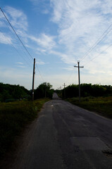 Fototapeta na wymiar Road in Ukraine in the village in the evening against the sky