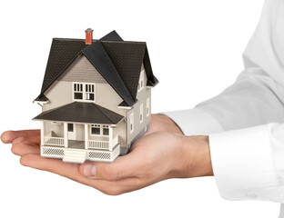 Men's Cupped Hands Holding a Model of a House - Isolated