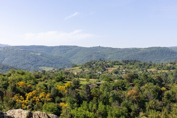 Landscape view of the green autumn trees on the hills in the countryside