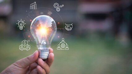 holding a bright light bulb. Concept of Ideas for presenting new ideas Great inspiration and...