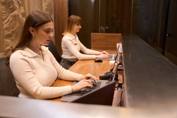 Focused woman administrators working together at reception room