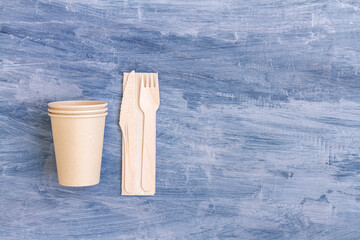 zero waste, plastic free,recyclable, sustainable utensils including fork, spoon, knife, cups and a napkin with copy space. Top view, overhead view ,above view or a flat lay composition