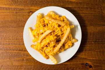 Crinkle cut fries with cheese sauce