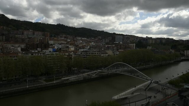 Aerial view of pedestrians at Zubizuri bridge in Bilbao, Spain