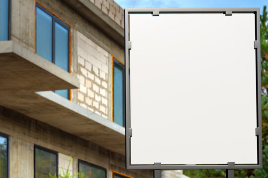 Construction banner. Empty signboard. Unfinished brick house. Copy space on white. Mock up for construction company. Metal signboard. Place for advertising construction services. Art focus. 3d image