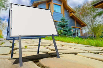 Portable outdoor signboard. Empty banner near country house. Metal signboard on walkway of private cottage. Place to message realtor. Signboard for real estate company. Selective focus. 