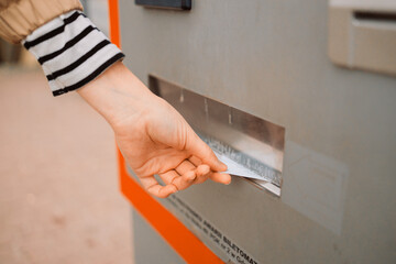 Closeup of woman paying for service underground parking or buying a subway or train ticket using an...