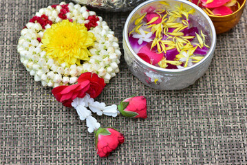 Jasmine water and rose petals in a bowl for Songkran festival in Thailand. with space for text.