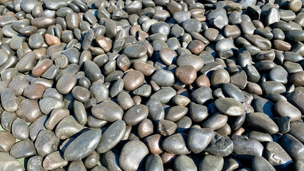 Black cobblestone wallpaper lit by sunlight