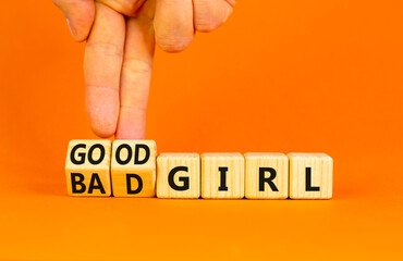 Good or bad girl symbol. Concept word Good girl Bad girl on wooden cubes. Businessman hand. Beautiful orange table orange background. Business psychological good or bad girl concept. Copy space.