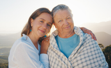 Portrait of two women young and elderly. Young woman hugs senior caucasian woman outdoor at sunrise. Models look into the camera - 589948208