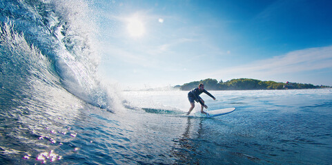 Surfer rides the ocean wave in the Maldives
