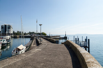 Neuchatel Lake in Switzerland seen from the port promenade of Estavayer-le-Lac, with plants and...