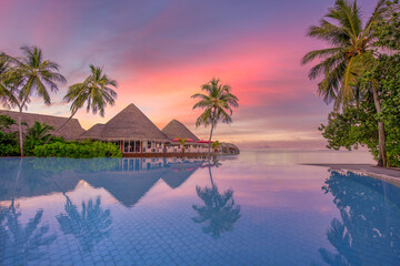 Tranquil luxury sunset over infinity pool swimming summer beachfront resort, tropical landscape. Beautiful reflection clouds palm trees as holiday vacation background. Amazing travel island beach