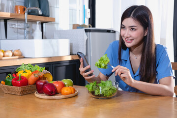 Diet, white-skinned young Asian woman in a blue shirt eating vegetable salad and apples as a healthy diet, opting for junk food. Female nutritionist losing weight. healthy eating concept.