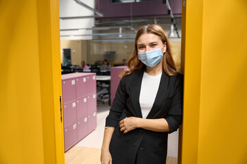 Fototapeta na wymiar Portrait of female worker standing in office