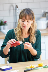 Young woman disinfecting a wound on her finger.