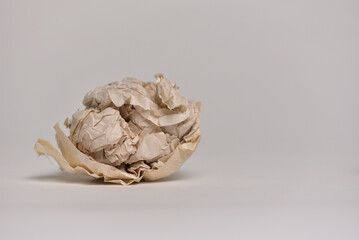 Crumpled brown paper on a white background. concept of disappointment, failure