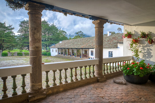 View of an old colonial farm house from inside of one its cozy terraces, on an overcast and rainy afternoon. Ibarra, Imbabura Province, Ecuador.