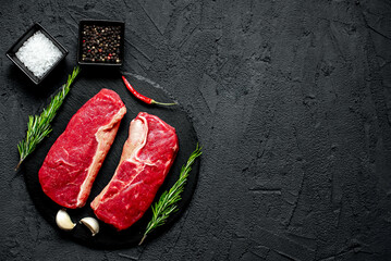 raw beef steak on stone background with copy space for your text