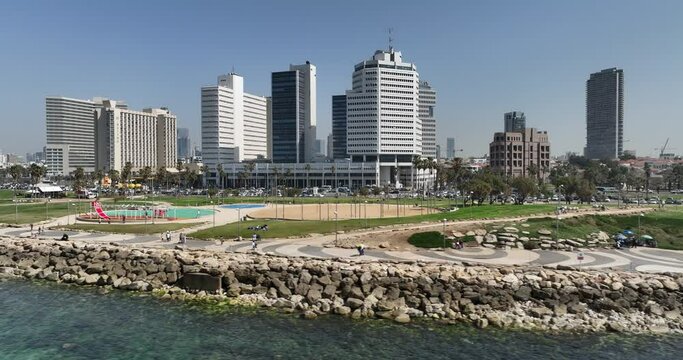 Aerial footage Tel Aviv beach promenade with the line of hotels in the background. Filmed in C4K Apple ProRes 422 HQ