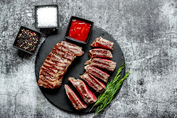 grilled beef steak on stone background