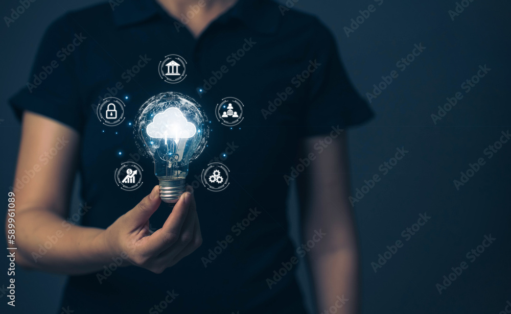 Poster businessman is holding a light bulb that lights up. the concept of uploading data via cloud technolo