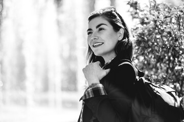 Modern, beautiful and young executive: sophisticated woman with sunglasses and backpack, happy at...