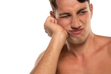 Closeup portrait of shirtless 20s man with toothache isolated over white background