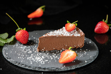 Chocolate Cake. Dark chocolate cake decorated with strawberries and coconut flakes.