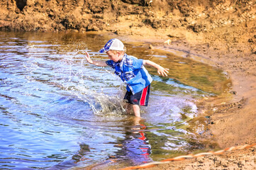 Boy splashes water in the river, Gorokhovets