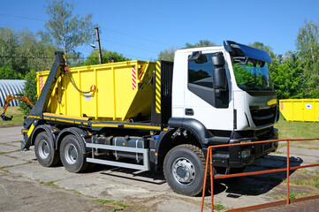 Radioactive waste storage container loaded on a truck crane platform