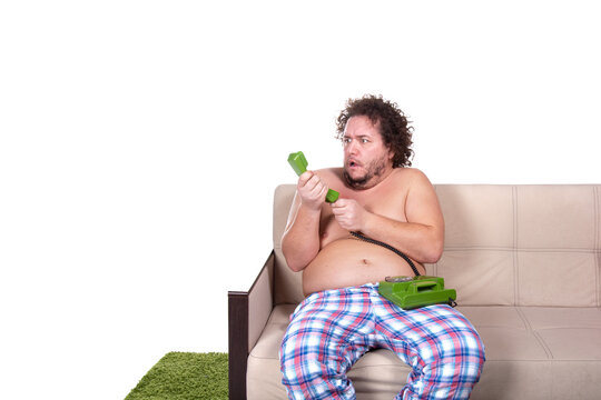 Funny fat man is sitting on the couch. Diet and healthy lifestyle.