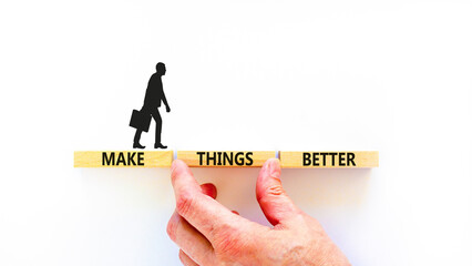 Make things better symbol. Concept words Make things better on wooden block on a beautiful white table white background. Businessman hand. Business and make things better concept. Copy space.