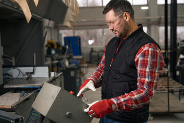 Adult man working on machine in the workshop