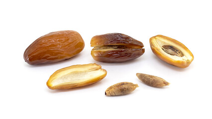 Whole dates, halved dates and date pits on white isolated background