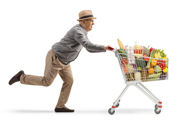 Full length shot of an elderly gentleman running with a shopping cart