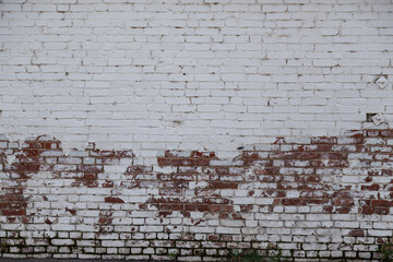 Old painted rouge worn brick wall 