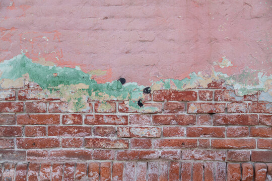 Old painted rouge worn brick wall © Евгений Суковатых