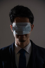 Man wearing a mask over his eyes.