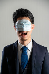 Screaming man wearing a mask over his eyes.