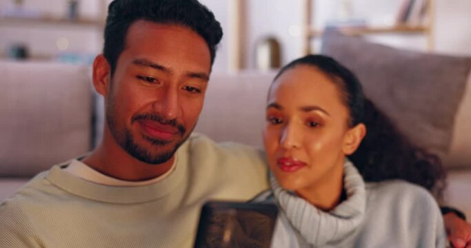 Phone, relax and talking couple watch social media video, streaming subscription content or browse website. Love bond, hug and fire place man, woman or online shopping people surfing internet at home
