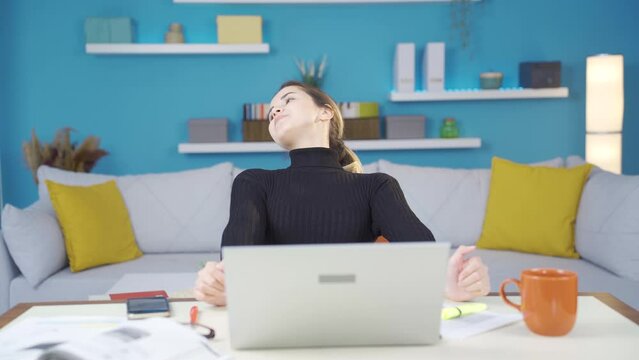 Young entrepreneur woman working in home office is relaxing and finding peace.
Beautiful and attractive young entrepreneur woman working from home gets things done and relax, happy.
