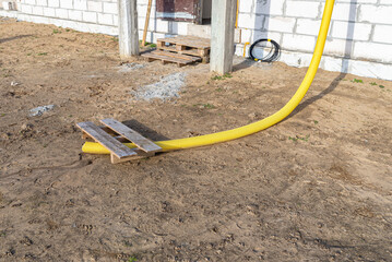 100mm diameter yellow PVC pipe connected to the end of the gutter on the roof, protected against...