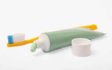 Tube of toothpaste and toothbrush isolated on white background. Close-up. Prevention of dental plaque and caries. Fresh breath. Dentistry concept. Oral care.