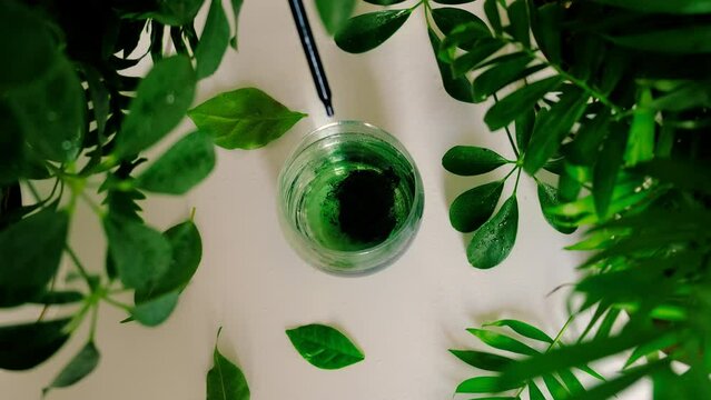Liquid chlorophyll in a glass. Selective focus.