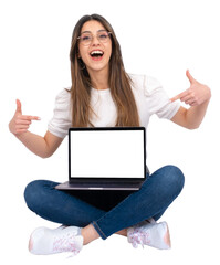 Happy cheerful caucasian teen girl sitting on the  ground and showing laptop. Cross-legged posing...