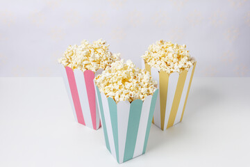 Popcorn inside bowls decorated with colorful stripes.