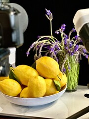 Image of fresh lemons, lavender flowers with camera in the foreground